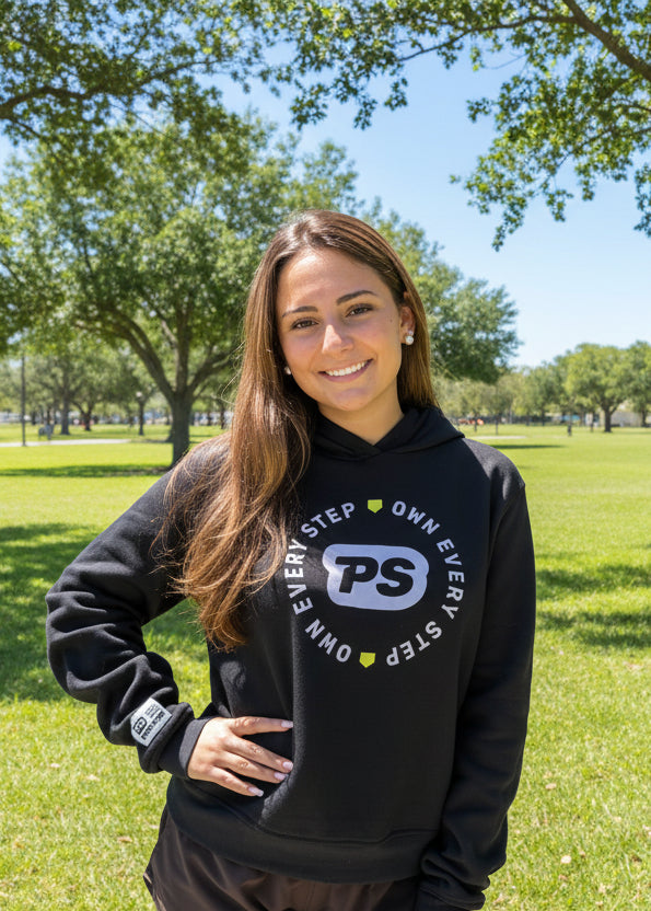 Teenager wearing a black Prep Step hoodie with a logo design